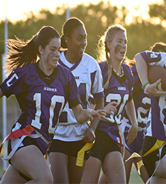 Female students playing flag football