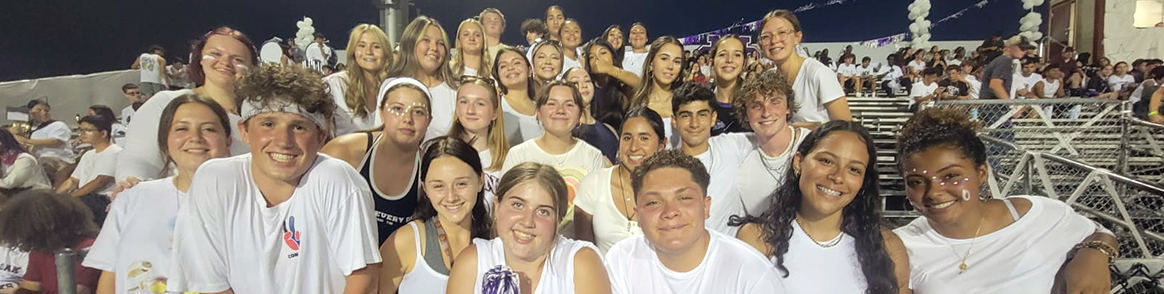 Group of happy, spirited students in the football stands