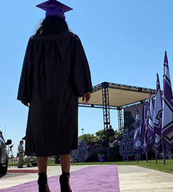 Female student preparing to walk the purple carpet for graduation