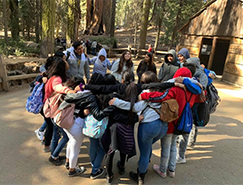 Students posing in a group hug outside